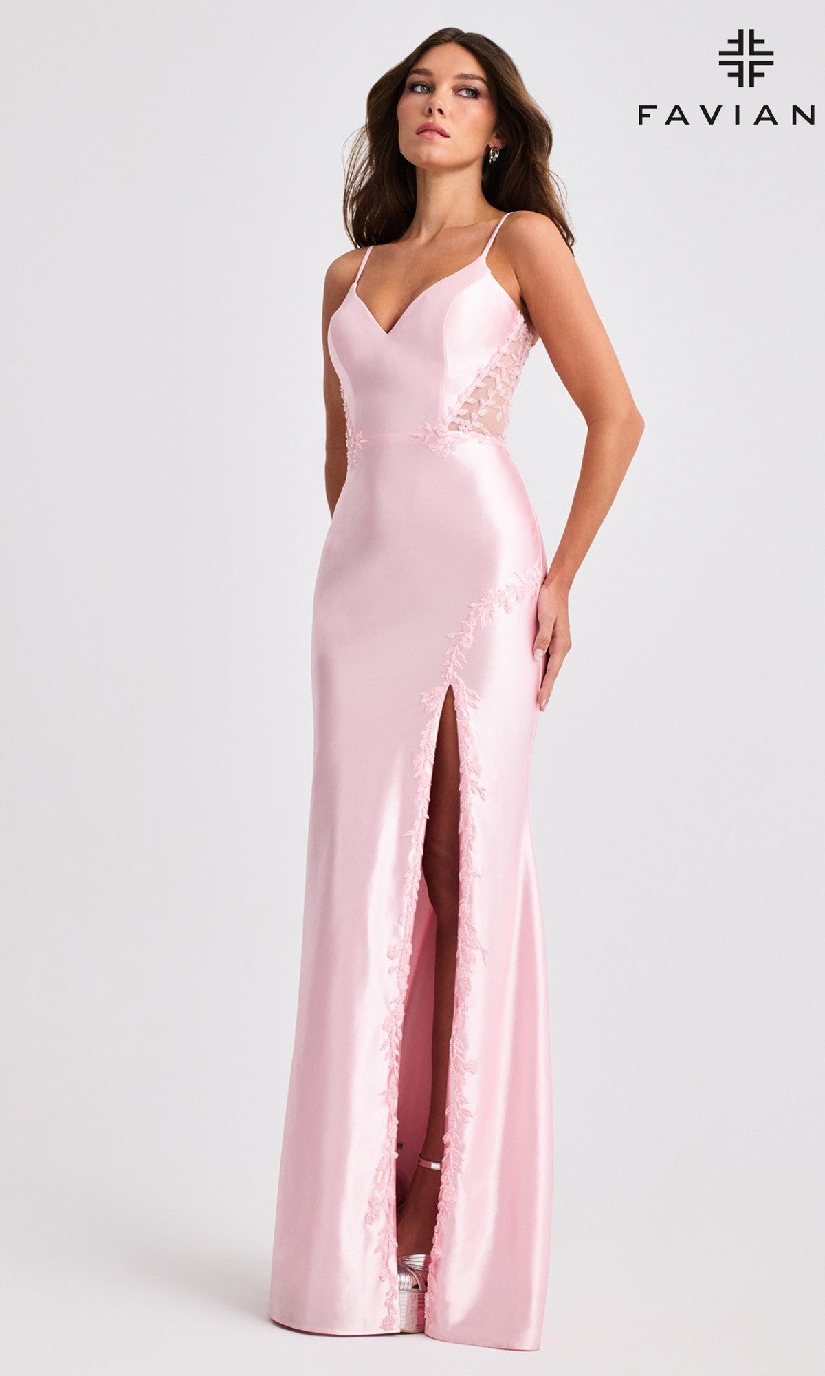 A woman poses against a plain background with the Faviana logo, wearing the Long Prom Dress: Faviana 11466—a sleeveless light pink satin gown featuring lace side panels, a fitted silhouette, thigh-high slit, and spaghetti straps.